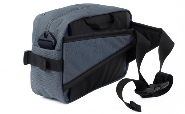 A 3/4 shot of the Le Grand Derriere showing the side and rear of the pack with its hip belts out and connected.
